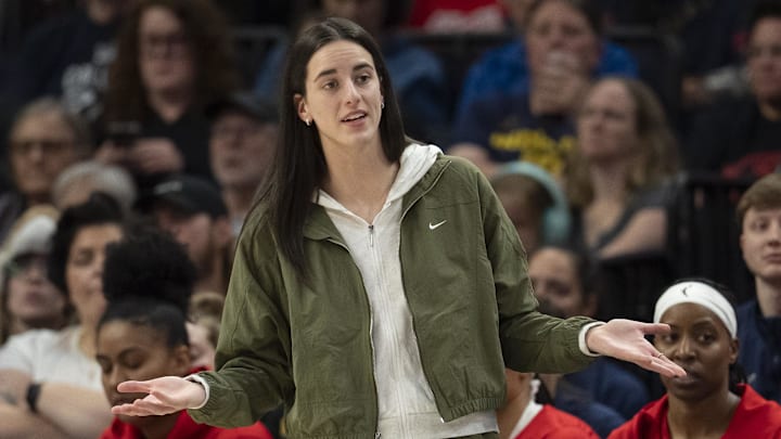 Aug 24, 2025; Minneapolis, Minnesota, USA; Indiana Fever guard Caitlin Clark (22) looks on from the bench against the Minnesota Lynx in the second half at Target Center. Mandatory Credit: Jesse Johnson-Imagn Images