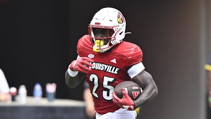 Aug 31, 2024; Louisville, Kentucky, USA; Louisville Cardinals running back Isaac Brown (25) runs the ball against Austin Peay Governors defensive back Cinque Williams (4) during the second quarter at L&N Federal Credit Union Stadium. Louisville defeated Austin Peay 62-0. Aug 31, 2024; Louisville, Kentucky, USA; Louisville Cardinals running back Isaac Brown (25) runs the ball against Austin Peay Governors defensive back Cinque Williams (4) during the second quarter at L&N Federal Credit Union Stadium. Louisville defeated Austin Peay 62-0.