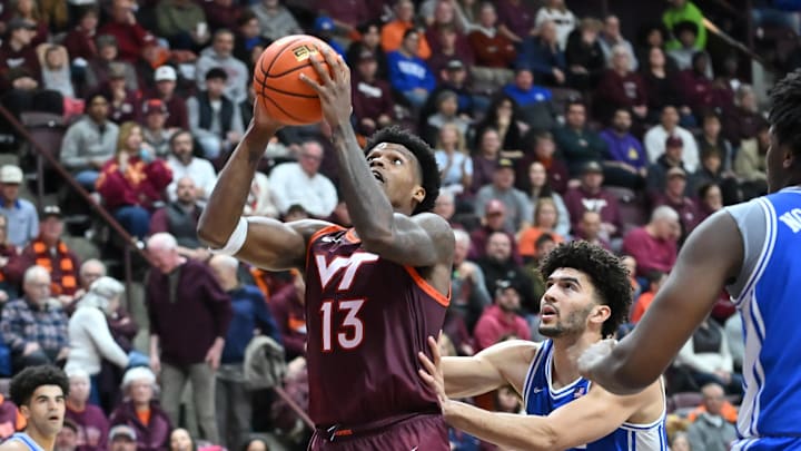 Jan 31, 2026; Blacksburg, Virginia, USA;  Virginia Tech Hokies forward Amani Hansberry (13) looks to shoot defended by Duke Blue Devils forward Cameron Boozer (12)during the second half at Cassell Coliseum. Mandatory Credit: Brian Bishop-Imagn Images