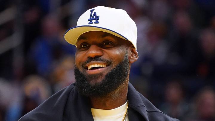 Los Angeles Lakers forward LeBron James (23), wearing a Los Angeles Dodgers hat, watches from the sideline during a break against the Golden State Warriors in the third quarter at Chase Center. 