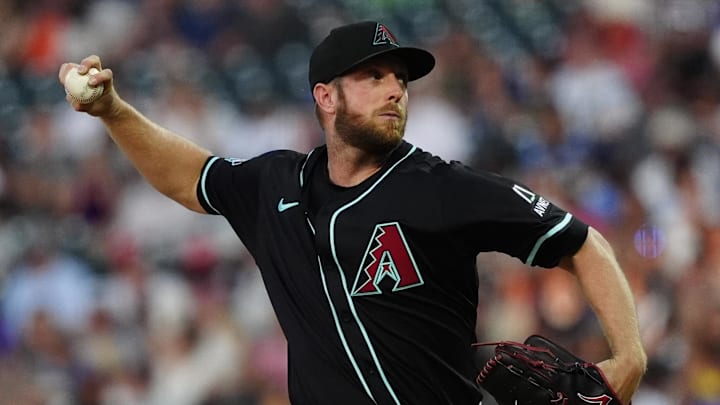 Jun 21, 2025; Denver, Colorado, USA; Arizona Diamondbacks starting pitcher Merrill Kelly (29) delivers a pitch in the fourth inning against the Colorado Rockies at Coors Field. Mandatory Credit: Ron Chenoy-Imagn Images