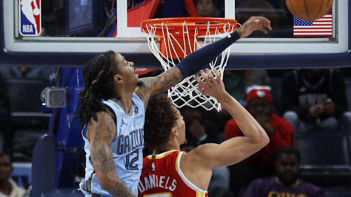 Jan 21, 2026; Memphis, Tennessee, USA; Memphis Grizzlies guard Ja Morant (12) blocks a shot attempt by Atlanta Hawks guard Dyson Daniels (5) during the fourth quarter at FedExForum. Mandatory Credit: Petre Thomas-Imagn Images