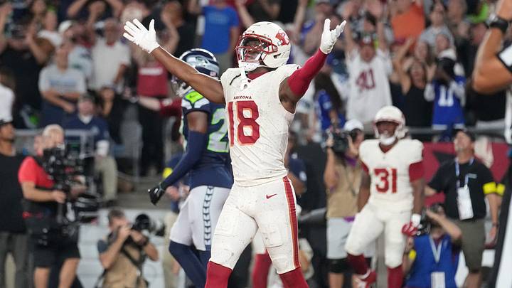 Marvin Harrison Jr. (18) celebrates a touchdown by teammate Emari Demercado (31) to tie the game at 20-20 against the Seattle Seahawks at State Farm Stadium in Glendale.