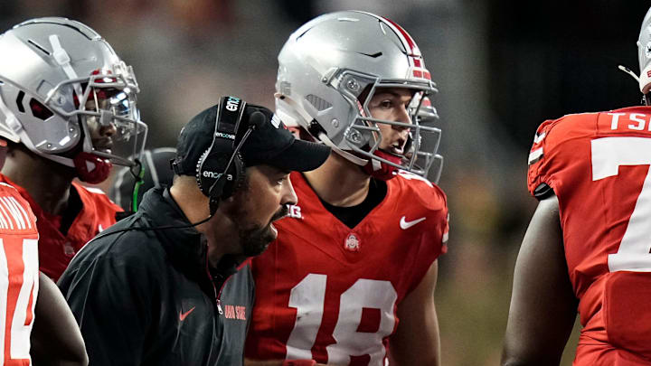Sep 7, 2024; Columbus, Ohio, USA; Ohio State Buckeyes head coach Ryan Day talks to quarterback Will Howard (18) in the huddle during the second half of the NCAA football game against the Western Michigan Broncos at Ohio Stadium.