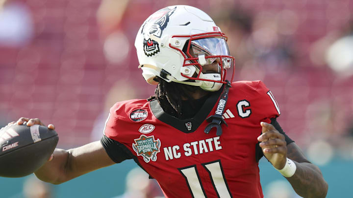 Dec 19, 2025; Tampa, FL, USA; NC State Wolfpack quarterback CJ Bailey (11) throws a pass against the Memphis Tigers in the first quarter during the Gasparilla Bowl at Raymond James Stadium. Mandatory Credit: Nathan Ray Seebeck-Imagn Images
