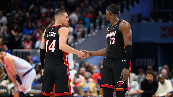Mar 31, 2025; Washington, District of Columbia, USA; Miami Heat guard Tyler Herro (14) and center Bam Adebayo (13) react during the third quarter against the Washington Wizards at Capital One Arena. Mandatory Credit: Reggie Hildred-Imagn Images