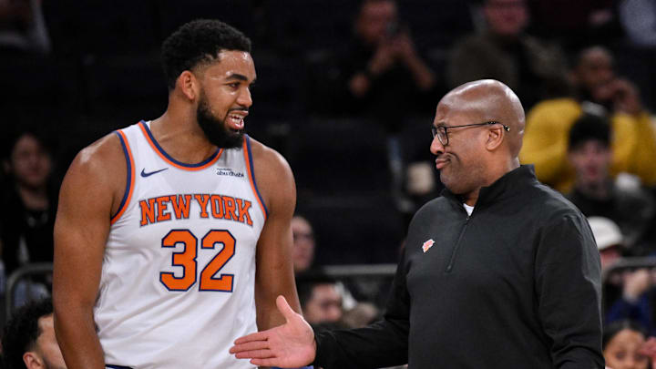 Oct 9, 2025; New York, New York, USA; New York Knicks head coach Mike Brown reacts as he talks with center/forward Karl-Anthony Towns (32) during the first half against the Minnesota Timberwolves at Madison Square Garden. Mandatory Credit: John Jones-Imagn Images