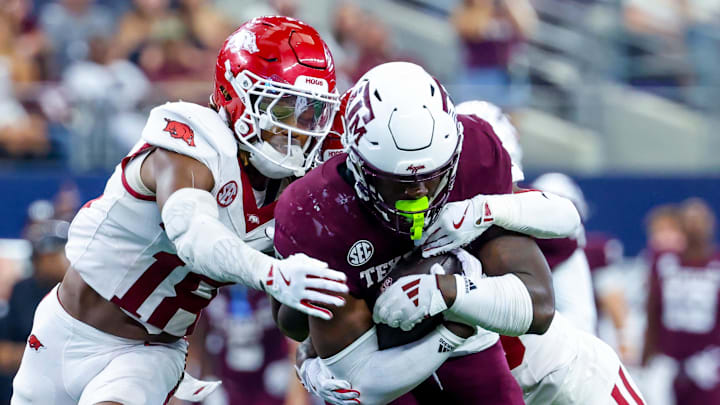 Texas A&M Aggies running back Le'Veon Moss (8) runs with the ball as Arkansas Razorbacks defensive back TJ Metcalf (18) defends during the second half at AT&T Stadium. Texas A&M Aggies running back Le'Veon Moss (8) runs with the ball as Arkansas Razorbacks defensive back TJ Metcalf (18) defends during the second half at AT&T Stadium.