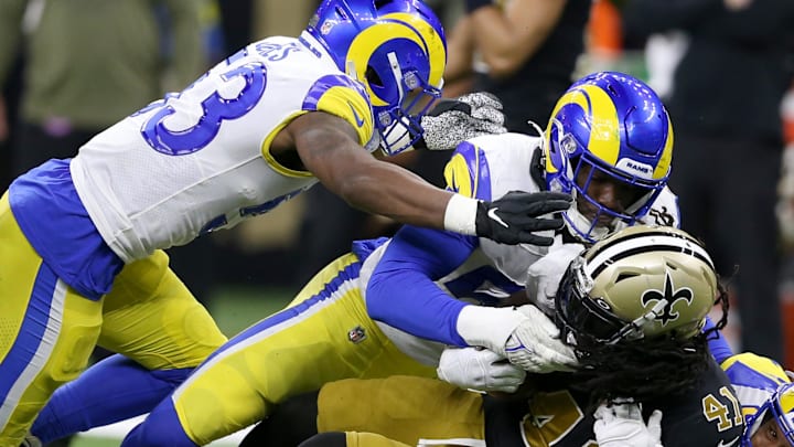 Nov 20, 2022; New Orleans, Louisiana, USA; New Orleans Saints running back Alvin Kamara (41) is tackled by Los Angeles Rams linebackers Ernest Jones (53) and Leonard Floyd (54) in the second quarter at the Caesars Superdome. Mandatory Credit: Chuck Cook-Imagn Images