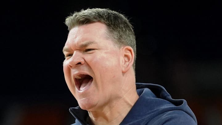 Apr 3, 2026; Indianapolis, IN, USA; Arizona Wildcats head coach Tommy Lloyd directs players during a practice session ahead of the Final Four of the men's 2026 NCAA Tournament at Lucas Oil Stadium. Mandatory Credit: Robert Deutsch-Imagn Images Apr 3, 2026; Indianapolis, IN, USA; Arizona Wildcats head coach Tommy Lloyd directs players during a practice session ahead of the Final Four of the men's 2026 NCAA Tournament at Lucas Oil Stadium. Mandatory Credit: Robert Deutsch-Imagn Images