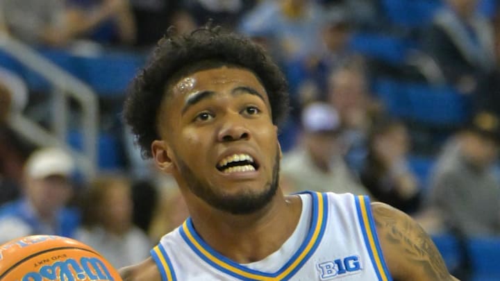 Jan 24, 2026; Los Angeles, California, USA;  UCLA Bruins guard Donovan Dent (2) is defended by Northwestern Wildcats guard Jake West (3) in the first half at Pauley Pavilion presented by Wescom Financial. Mandatory Credit: Jayne Kamin-Oncea-Imagn Images