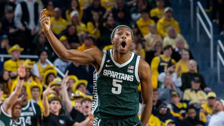 Michigan State’s Tre Holloman (5) celebrates after his team scores a basket against Michigan’s defense during the second half of their matchup at Crisler Center in Ann Arbor on Friday, Feb. 21, 2025.