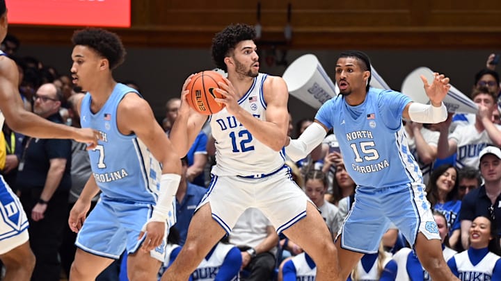 Mar 7, 2026; Durham, North Carolina, USA; Duke Blue Devils forward Cameron Boozer (12) looks to pass as North Carolina Tar Heels forward Jarin Stevenson (15) defends during the first half at Cameron Indoor Stadium. Mandatory Credit: Rob Kinnan-Imagn Images