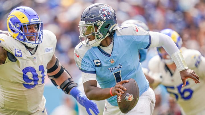 Tennessee Titans quarterback Cam Ward (1) evades Los Angeles Rams defensive end Kobie Turner (91) during the fourth quarter at Nissan Stadium in Nashville, Tenn., Sunday, Sept. 14, 2025.
