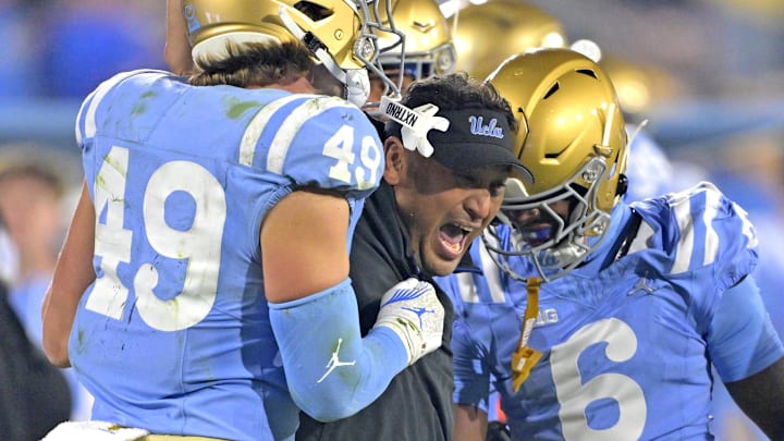 Nov 8, 2024; Pasadena, California, USA; UCLA Bruins defensive coordinator Ikaika Malloe, center, celebrates with linebacker Carson Schwesinger (49) defensive back Jaylin Davies (6) after an interception in the second half against the Iowa Hawkeyes at the Rose Bowl. Mandatory Credit: Jayne Kamin-Oncea-Imagn Images Nov 8, 2024; Pasadena, California, USA; UCLA Bruins defensive coordinator Ikaika Malloe, center, celebrates with linebacker Carson Schwesinger (49) defensive back Jaylin Davies (6) after an interception in the second half against the Iowa Hawkeyes at the Rose Bowl. Mandatory Credit: Jayne Kamin-Oncea-Imagn Images
