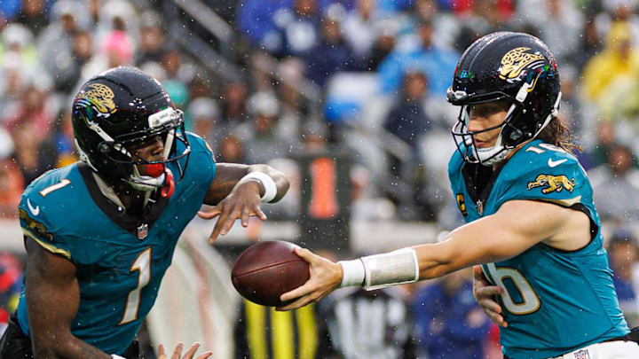 Dec 7, 2025; Jacksonville, Florida, USA; Jacksonville Jaguars quarterback Trevor Lawrence (16) hands the ball to Jacksonville Jaguars running back Travis Etienne Jr. (1) against the Indianapolis Colts during the second half at EverBank Stadium. 