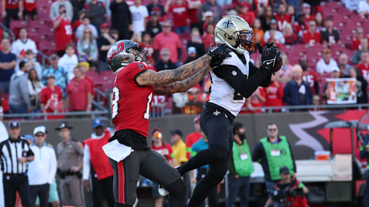 Dec 31, 2023; Tampa, Florida, USA; New Orleans Saints cornerback Paulson Adebo (29) intercepted the ball for the 2-point conversion over Tampa Bay Buccaneers wide receiver Mike Evans (13) during the second half at Raymond James Stadium. Mandatory Credit: Kim Klement Neitzel-Imagn Images Dec 31, 2023; Tampa, Florida, USA; New Orleans Saints cornerback Paulson Adebo (29) intercepted the ball for the 2-point conversion over Tampa Bay Buccaneers wide receiver Mike Evans (13) during the second half at Raymond James Stadium. Mandatory Credit: Kim Klement Neitzel-Imagn Images