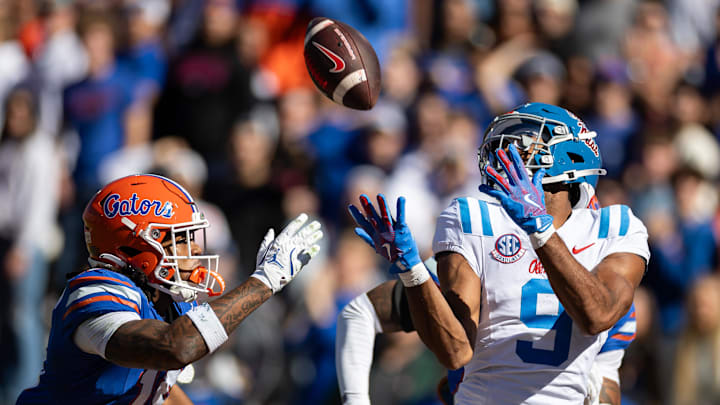 Nov 23, 2024; Gainesville, Florida, USA; Mississippi Rebels wide receiver Tre Harris (9) makes a catch for a touchdown over Florida Gators defensive back Bryce Thornton (18) during the first half at Ben Hill Griffin Stadium. Mandatory Credit: Matt Pendleton-Imagn Images