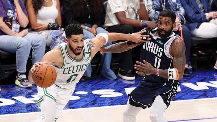Jun 14, 2024; Dallas, Texas, USA; Boston Celtics forward Jayson Tatum (0) drives to the basket against Dallas Mavericks guard Kyrie Irving (11) during the second quarter during game four of the 2024 NBA Finals at American Airlines Center. Mandatory Credit: Peter Casey-Imagn Images