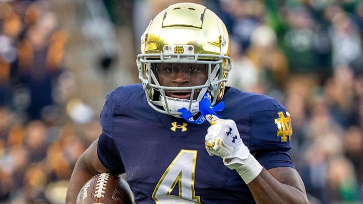 Nov 22, 2025; South Bend, Indiana, USA; Notre Dame Fighting Irish running back Jeremiyah Love (4) runs the ball against the Syracuse Orange during the first half at Notre Dame Stadium. Mandatory Credit: Michael Caterina-Imagn Images