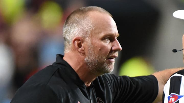 Nov 5, 2022; Raleigh, North Carolina, USA; North Carolina State Wolfpack head coach Dave Doeren (left) argues with officials during the second half at Carter-Finley Stadium.  The Wolf Pack won 30-21. Mandatory Credit: Rob Kinnan-Imagn Images