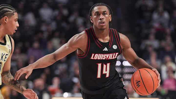Feb 7, 2026; Winston-Salem, North Carolina, USA; Louisville Cardinals guard Adrian Wooley (14) brings the ball up court against Wake Forest Demon Deacons guard Sebastian Akins (10) during the second half at Lawrence Joel Veterans Memorial Coliseum. Mandatory Credit: Jim Dedmon-Imagn Images