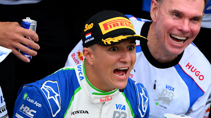 Isack Hadjar, Racing Bulls, celebrates his podium at the 2025 F1 Dutch Grand Prix with team principal Alan Permane and CEO Peter Bayer and a broken trophy. Circuit Zandvoort.