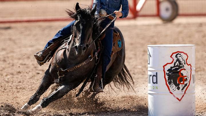 A barrel racer competing at the Cheyenne Frontier Days A barrel racer competing at the Cheyenne Frontier Days