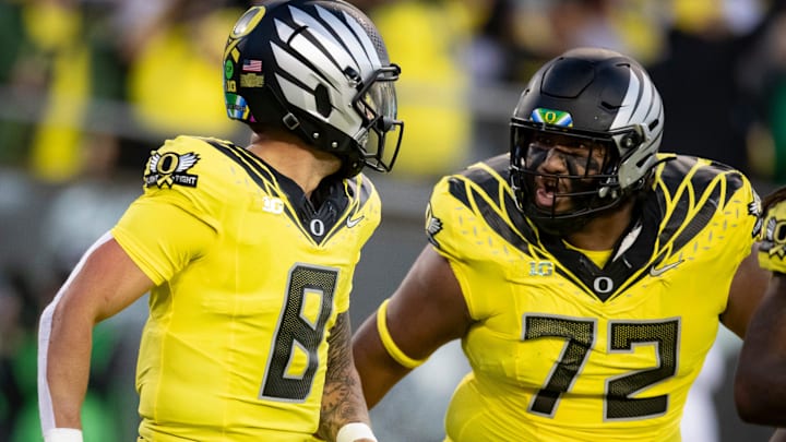 Oregon Ducks quarterback Dillon Gabriel, left, and offensive lineman Iapani Laloulu celebrate a touchdown run by Gabriel as the Ducks host the Spartans Friday, Oct. 4, 2024 at Autzen Stadium in Eugene, Ore.