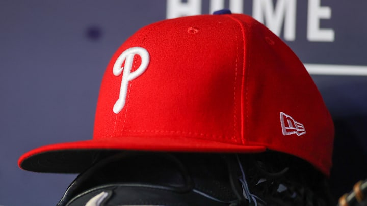 May 26, 2023; Atlanta, Georgia, USA; A detailed view of a Philadelphia Phillies hat and glove on the bench against the Atlanta Braves in the seventh inning at Truist Park. 