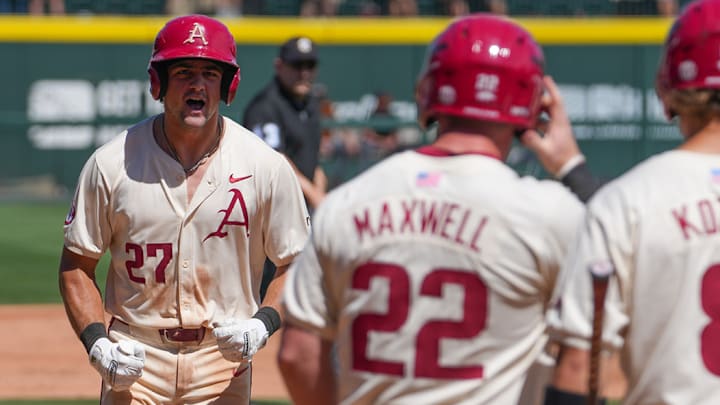 Ryder Helfrick celebrates after hitting a grand slam against the Tennessee Volunteers in the rubber game and series finale. The Razorbacks won 8-4. 