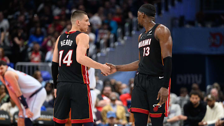 Mar 31, 2025; Washington, District of Columbia, USA; Miami Heat guard Tyler Herro (14) and center Bam Adebayo (13) react during the third quarter against the Washington Wizards at Capital One Arena. Mandatory Credit: Reggie Hildred-Imagn Images