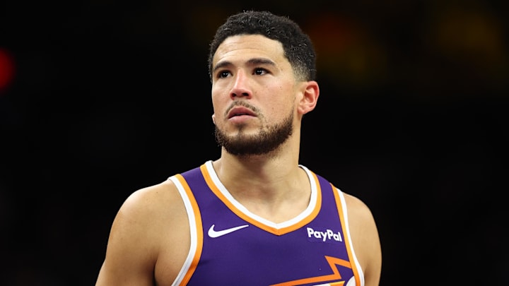 Dec 18, 2025; Phoenix, Arizona, USA; Phoenix Suns guard Devin Booker (1) against the Golden State Warriors at Mortgage Matchup Center. Mandatory Credit: Mark J. Rebilas-Imagn Images