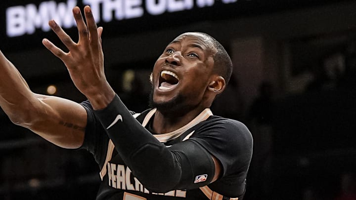 Mar 16, 2026; Atlanta, Georgia, USA; Atlanta Hawks forward Jonathan Kuminga (0) is called for an offensive foul on Orlando Magic guard Jalen Suggs (4) during the second half at State Farm Arena. Mandatory Credit: Dale Zanine-Imagn Images