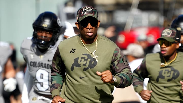 Nov 11, 2023; Boulder, Colorado, USA; Colorado Buffaloes head coach Deion Sanders runs on to the field before the first half against the Arizona Wildcats at Folsom Field. Mandatory Credit: Ron Chenoy-Imagn Images