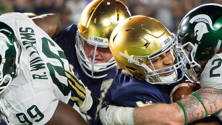 Sep 17, 2016; South Bend, IN, USA; Notre Dame Fighting Irish quarterback DeShone Kizer (14) fights his way into the end zone as Michigan State Spartans linebacker Chris Frey (23) defends in the fourth quarter at Notre Dame Stadium. MSU won 36-28. Mandatory Credit: Matt Cashore-Imagn Images