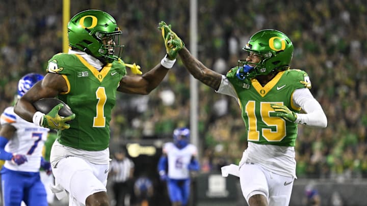 Sep 7, 2024; Eugene, Oregon, USA; Oregon Ducks wide receiver Traeshon Holden (1) high-fives wide receiver Tez Johnson (15) as he scores a touchdown during the second half against the Boise State Broncos at Autzen Stadium. Mandatory Credit: Troy Wayrynen-Imagn Images