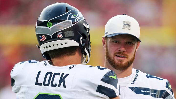 Seattle Seahawks quarterback Sam Darnold talks with quarterback Drew Lock before a game