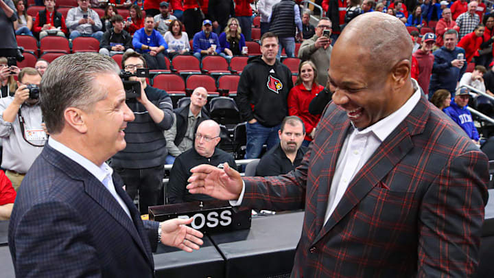 Kentucky's John Calipari and Louisville coach Kenny Payne meet each other at mid court before the game between the two schools on Thursday, Dec. 21, 2023