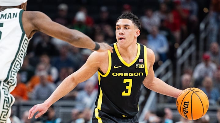 Mar 14, 2025; Indianapolis, IN, USA;  Oregon Ducks guard Jackson Shelstad (3) dribbles the ball while Michigan State Spartans guard Tre Holloman (5) defends in the second half  at Gainbridge Fieldhouse. Mandatory Credit: Trevor Ruszkowski-Imagn Images