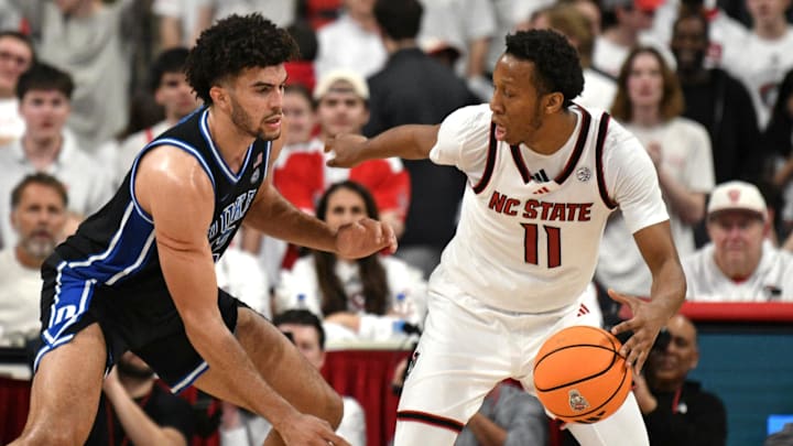 Mar 2, 2026; Raleigh, North Carolina, USA;  Duke Blue Devils forward Cameron Boozer (12) guards NC State Wolfpack guard Quadir Copeland (11) during the second half at Lenovo Center. Mandatory Credit: Zachary Taft-Imagn Images