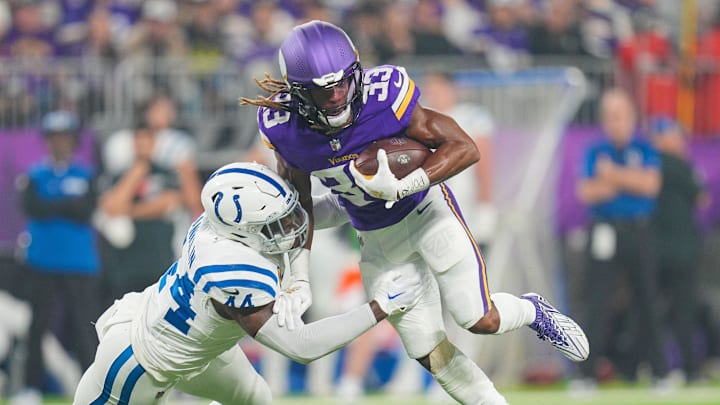 Nov 3, 2024; Minneapolis, Minnesota, USA; Minnesota Vikings running back Aaron Jones (33) runs with the ball against the Indianapolis Colts linebacker Zaire Franklin (44) in the first quarter at U.S. Bank Stadium.