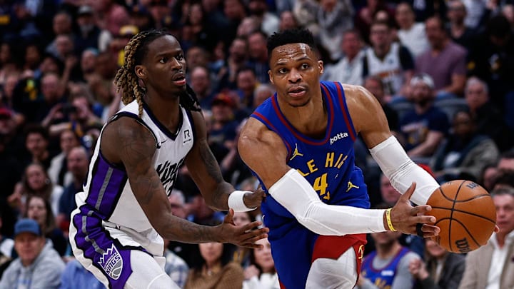Mar 5, 2025; Denver, Colorado, USA; Denver Nuggets guard Russell Westbrook (4) controls the ball as Sacramento Kings guard Keon Ellis (23) guards in the fourth quarter at Ball Arena. Mandatory Credit: Isaiah J. Downing-Imagn Images