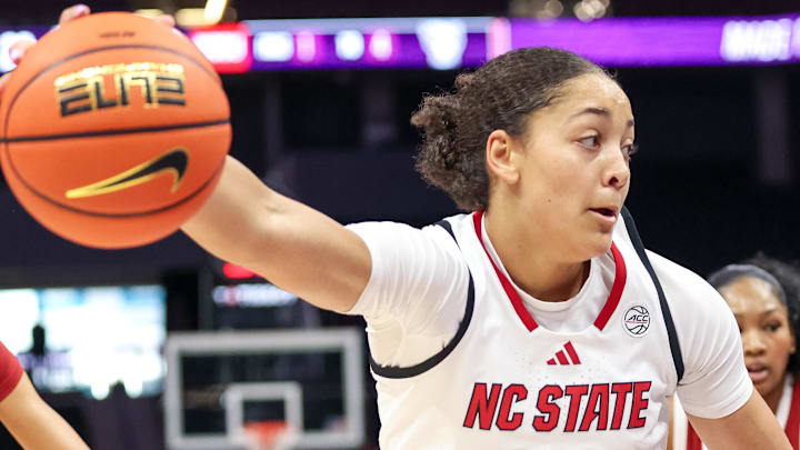 Nov 9, 2025; Charlotte, North Carolina, USA; NC State Wolfpack forward Khamil Pierre (12) controls the ball against the Southern California Trojans during the second quarter of the Ally Tipoff game at Spectrum Center. Mandatory Credit: Cory Knowlton-Imagn Images