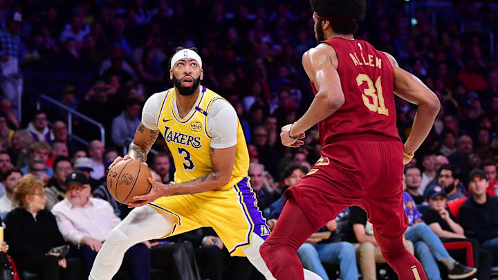 Dec 31, 2024; Los Angeles, California, USA; Los Angeles Lakers forward Anthony Davis (3) controls the ball against Cleveland Cavaliers center Jarrett Allen (31) during the first half at Crypto.com Arena. Mandatory Credit: Gary A. Vasquez-Imagn Images
