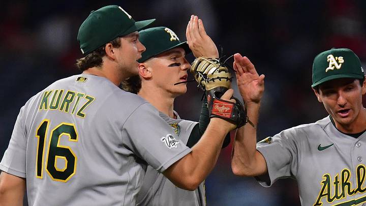 May 20, 2026; Anaheim, California, USA; Athletics first baseman Nick Kurtz (16) third baseman Zack Gelof (20) and second baseman Alika Williams (12) celebrate the victory against the Los Angeles Angels at Angel Stadium. Mandatory Credit: Gary A. Vasquez-Imagn Images