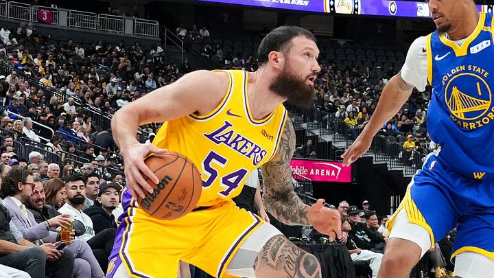 Oct 13, 2026; Las Vegas, Nevada, USA;  Los Angeles Lakers forward Sandro Mamukelashvili (54) drives against Golden State Warriors forward Yaxel Lendeborg (1) in the first quarter at T-Mobile Arena.  Mandatory Credit: Candice Ward-Imagn Images
