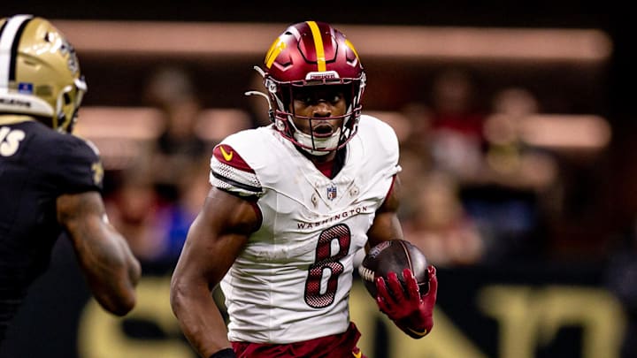 Dec 15, 2024; New Orleans, Louisiana, USA; Washington Commanders running back Brian Robinson Jr. (8) rushes against New Orleans Saints cornerback Will Harris (5) during the first half at Caesars Superdome. Mandatory Credit: Stephen Lew-Imagn Images Dec 15, 2024; New Orleans, Louisiana, USA; Washington Commanders running back Brian Robinson Jr. (8) rushes against New Orleans Saints cornerback Will Harris (5) during the first half at Caesars Superdome. Mandatory Credit: Stephen Lew-Imagn Images