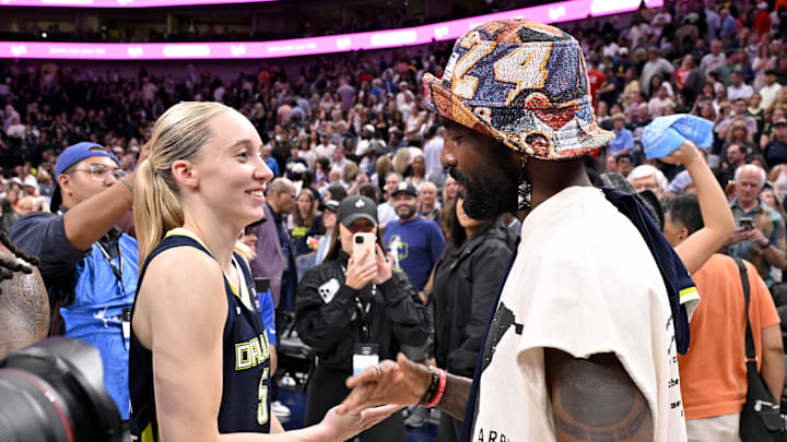 Dallas Mavericks point guard Kyrie Irving talks with Dallas Wings guard Paige Bueckers after a game. Dallas Mavericks point guard Kyrie Irving talks with Dallas Wings guard Paige Bueckers after a game.