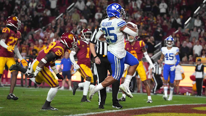 Nov 27, 2021; Los Angeles, California, USA; BYU Cougars running back Tyler Allgeier (25) scores a touchdown against the Southern California Trojans in the first half at United Airlines Field at Los Angeles Memorial Coliseum. Mandatory Credit: Kirby Lee-Imagn Images